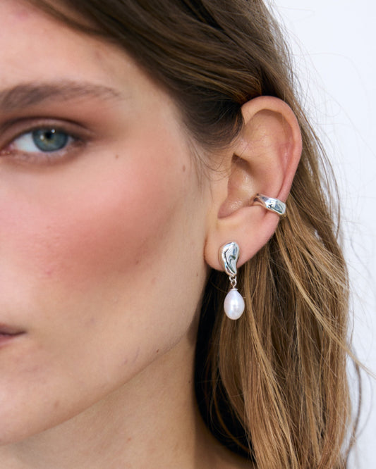 Sterling silver ear cuff worn on the ear as a sculptural everyday accent