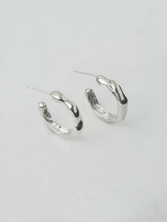 sculptural silver hoop earrings organic shape close up