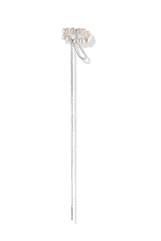 Pearl ear cuff with the chain threaded through a pierced earlobe
