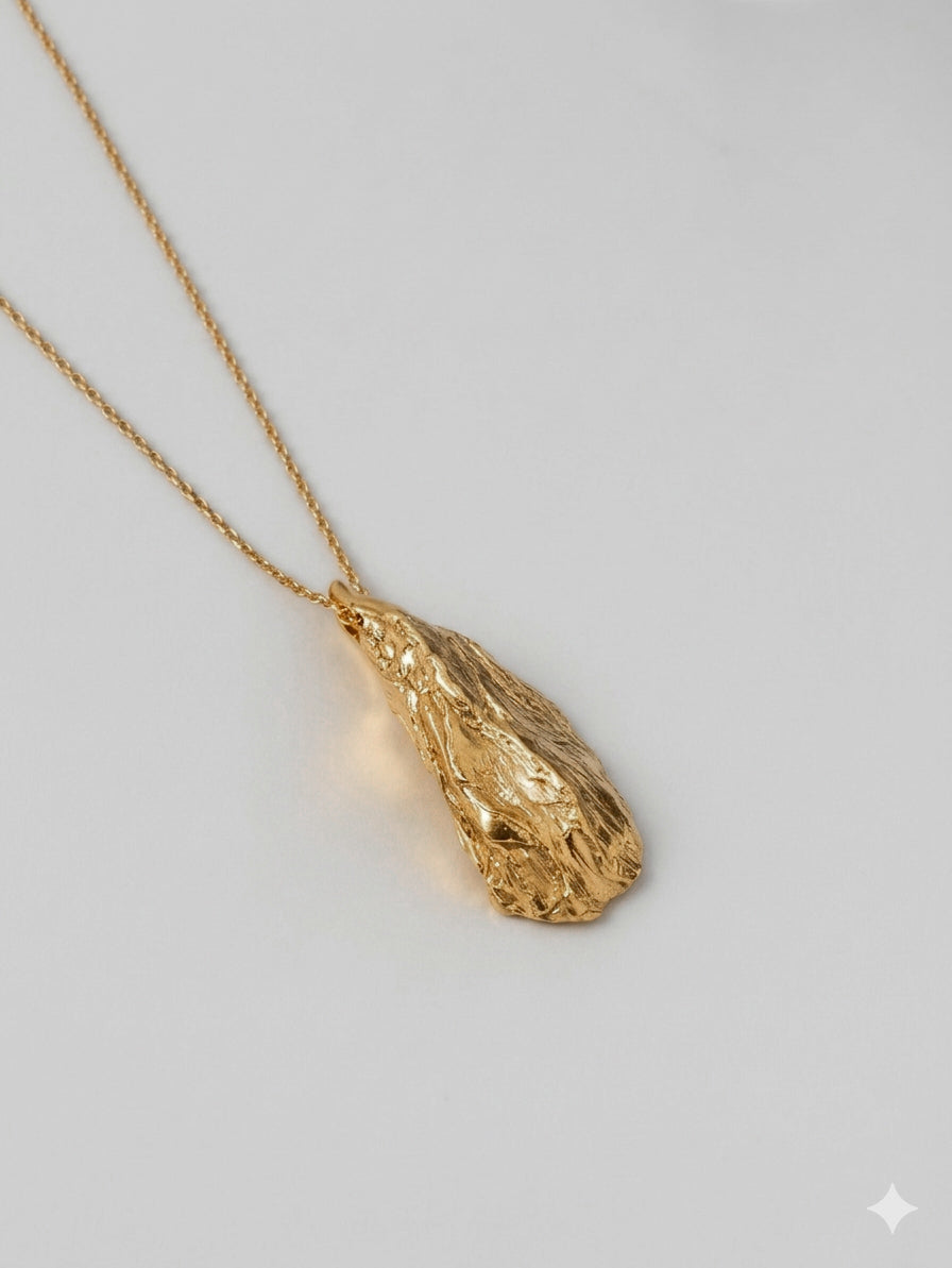 sculptural silver pendant textured organic shape close up