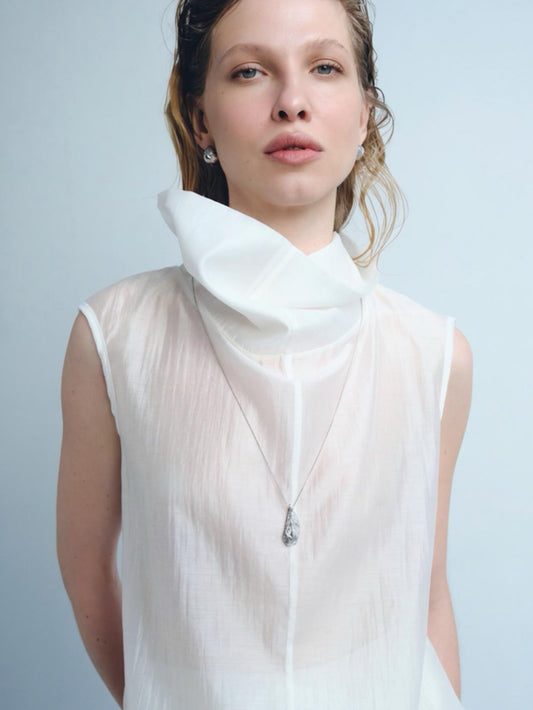 fluid silver necklace on body minimal styling fashion look