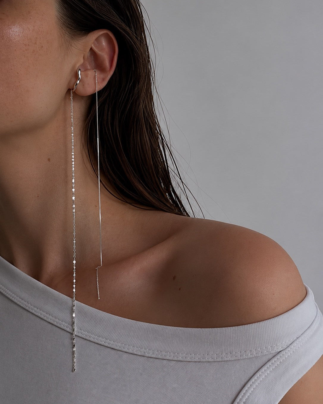Sculptural sterling silver Hidden Ear Cuff with elongated textured chains, minimalist modern jewelry design
