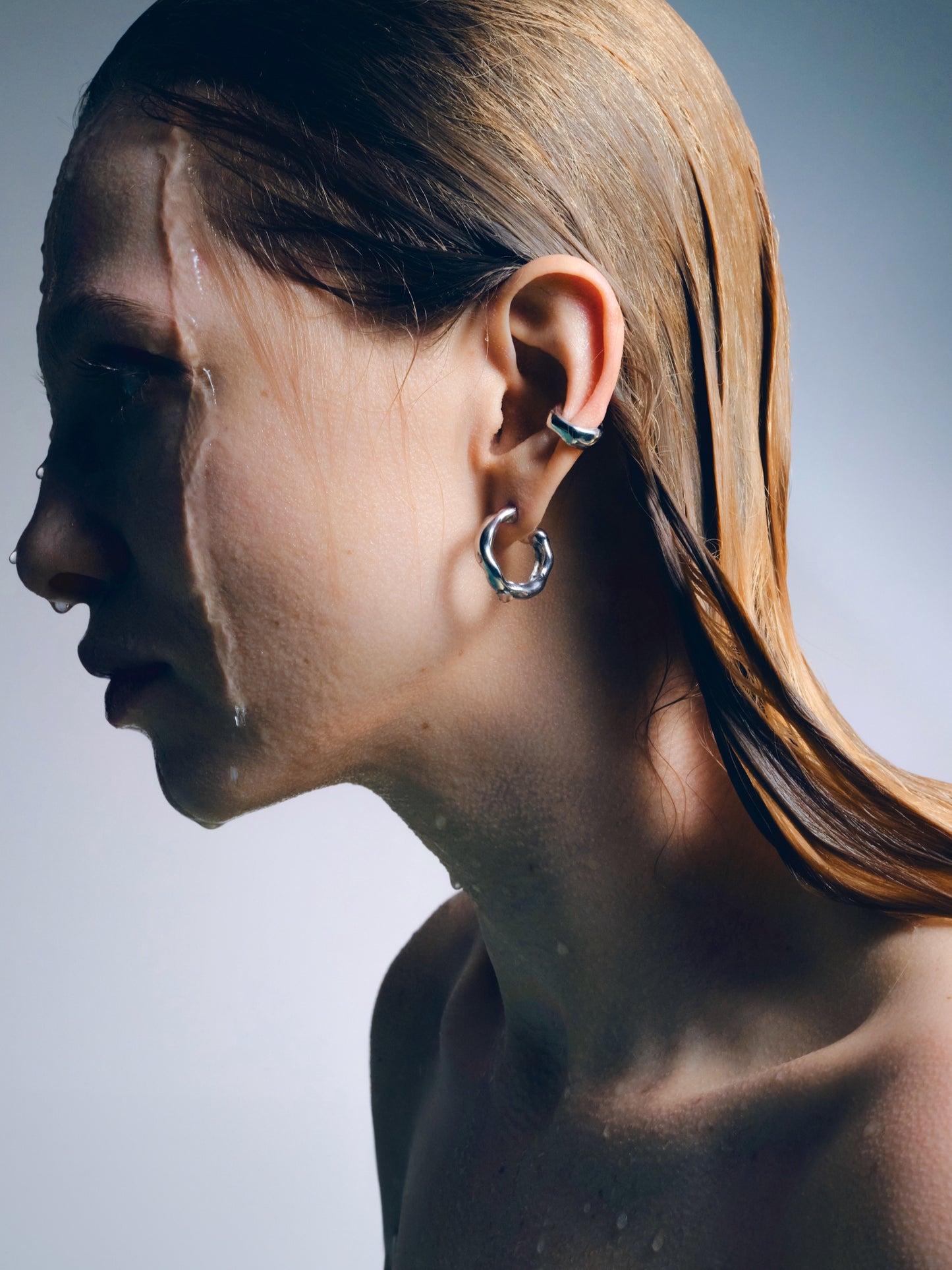 irregular silver hoop earrings sculptural design
