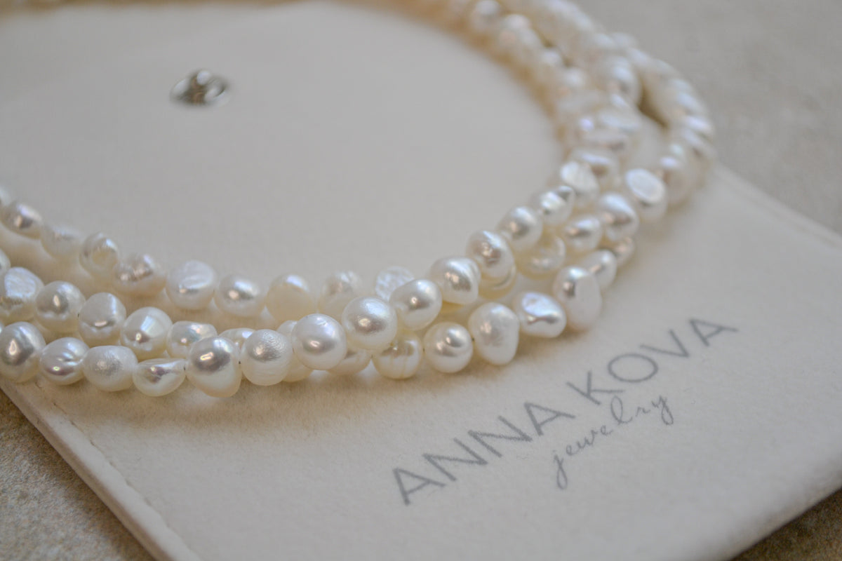 Close-up of the naturally varied pearl shapes on the TOCCOA triple-strand choker