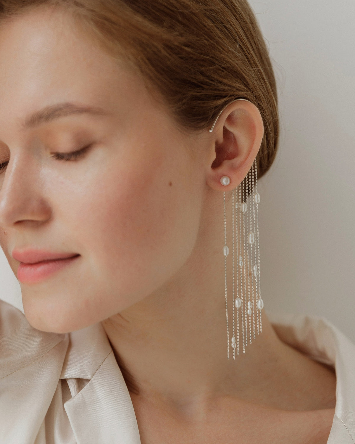 Malta pearl ear cuff worn on the ear with matching pearl stud earrings