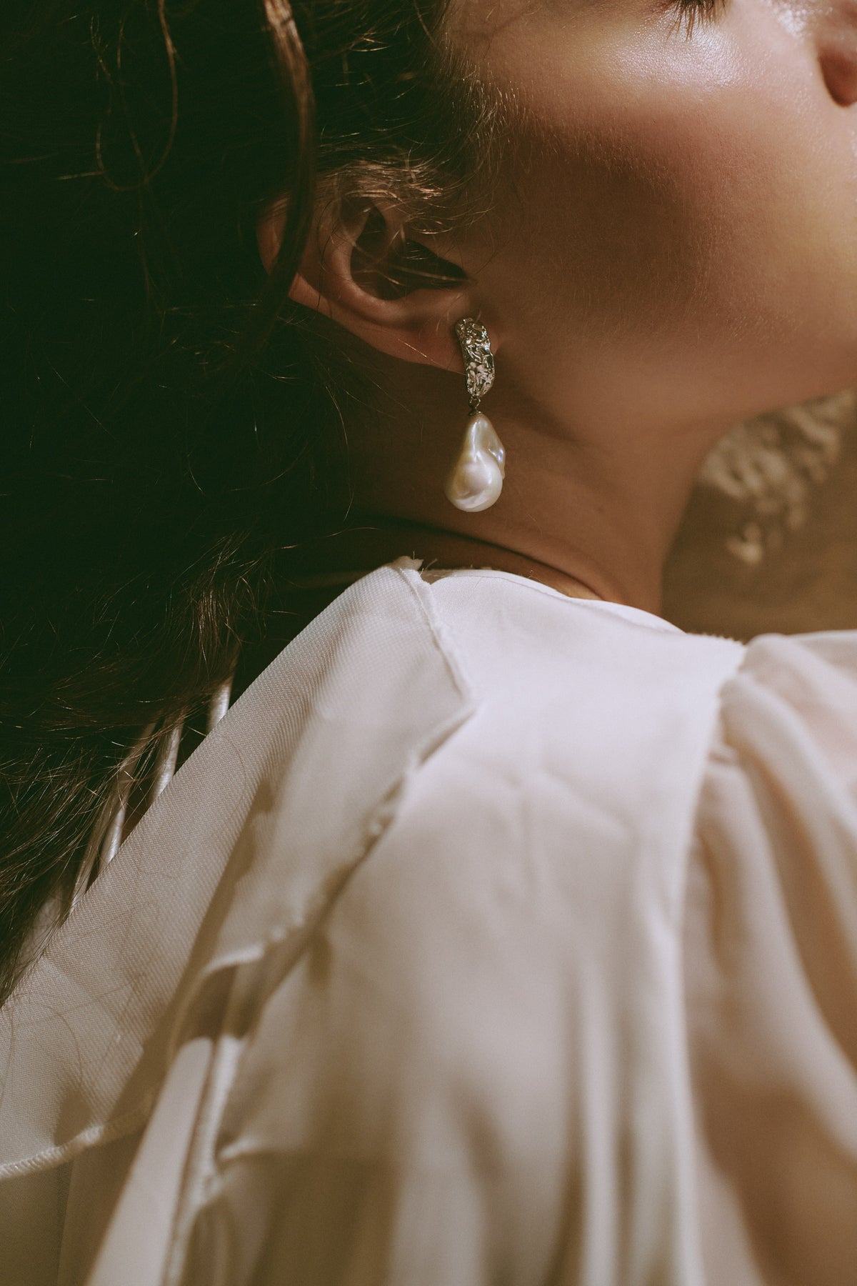 Statement baroque pearl earrings with organic shapes styled for a contemporary look
