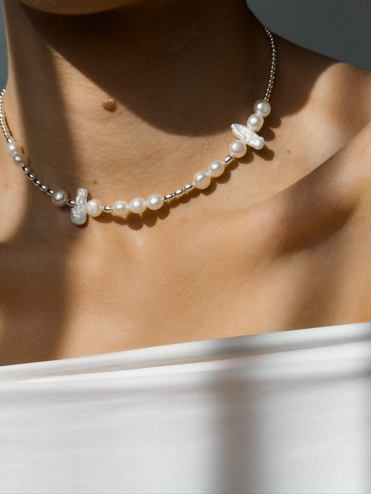 Close-up of the Morse choker showing natural pearls and silver Morse code beads