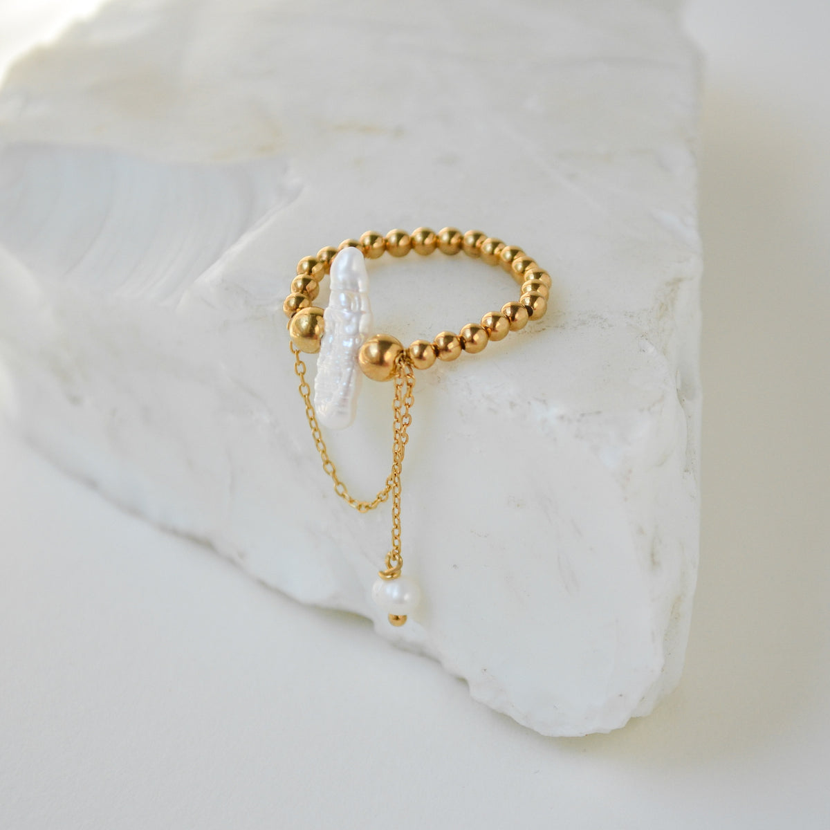 Kasei gold-plated sterling silver ring featuring a natural baroque pearl and delicate gold-plated silver chains.