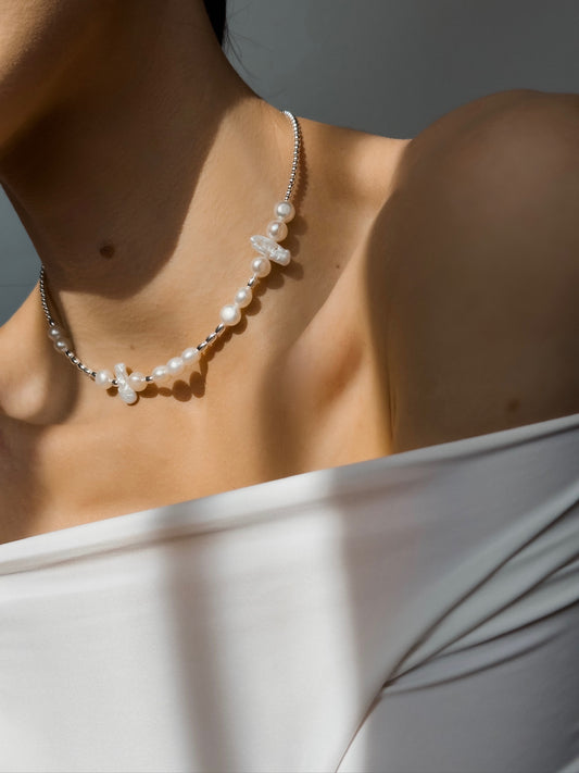 Morse Code pearl necklace worn around the neck