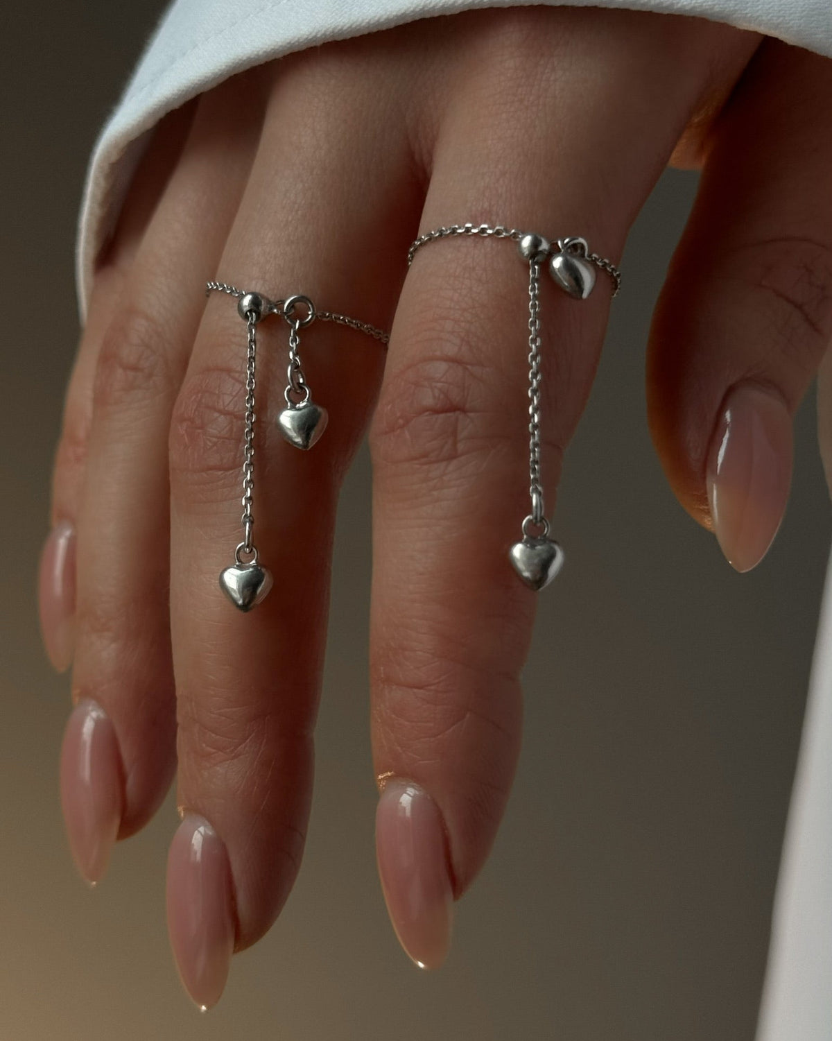 Nicole rhodium-plated sterling silver ring with two heart charms