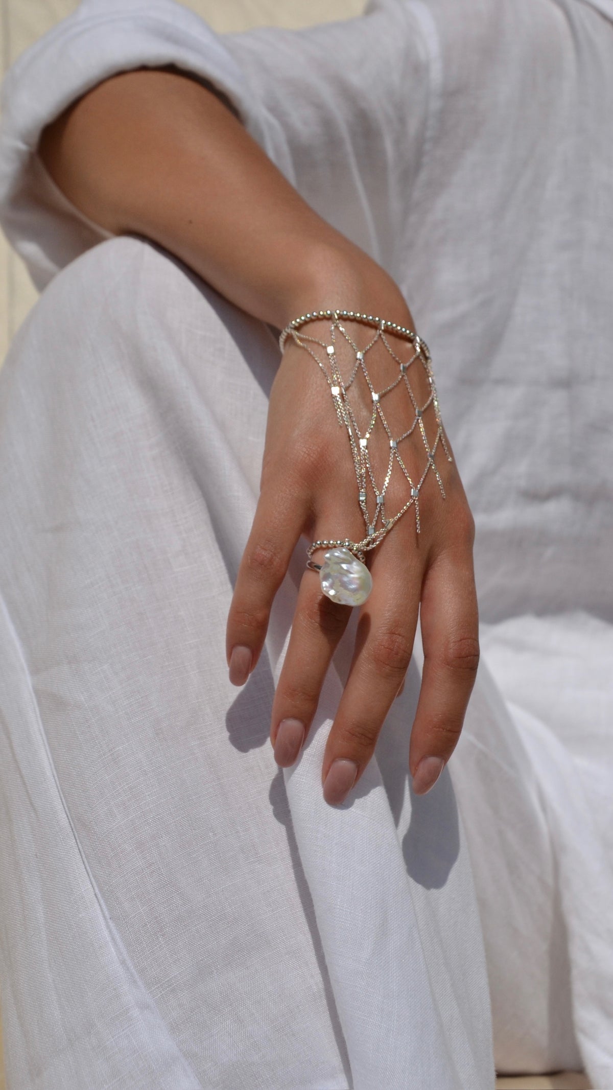MEDINA woven silver bracelet worn on the wrist, featuring rounded silver beads and chain links