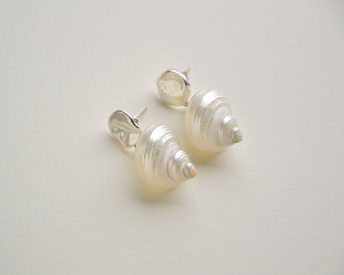 Close-up of the organic shell shapes and reflective silver studs on SirenCore earrings