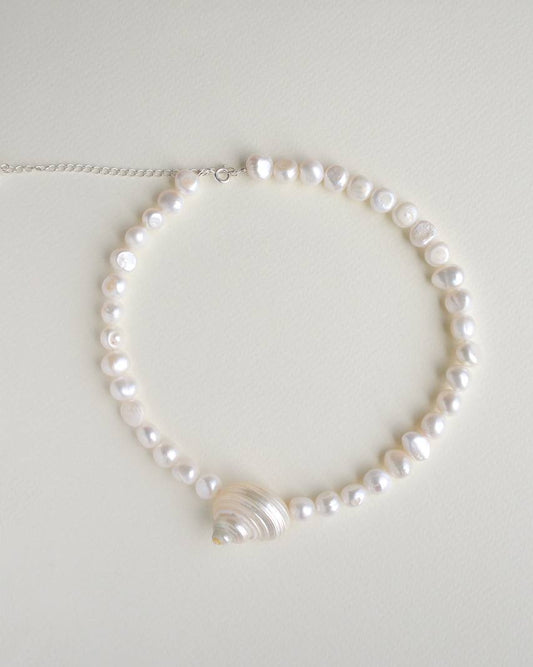SirenCore pearl choker with a single natural ocean shell and sterling silver details
