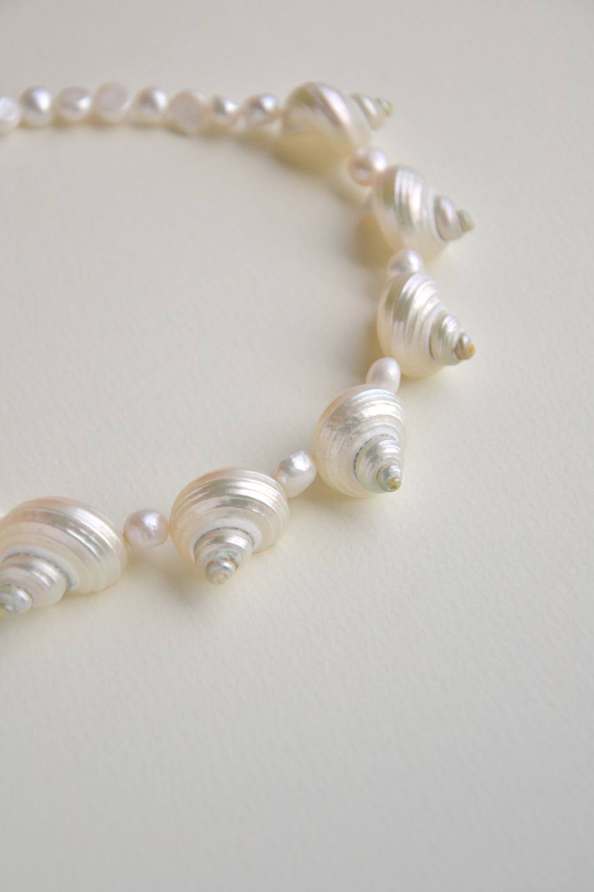 Close-up of the SirenCore choker showing natural pearls and seven shell accents