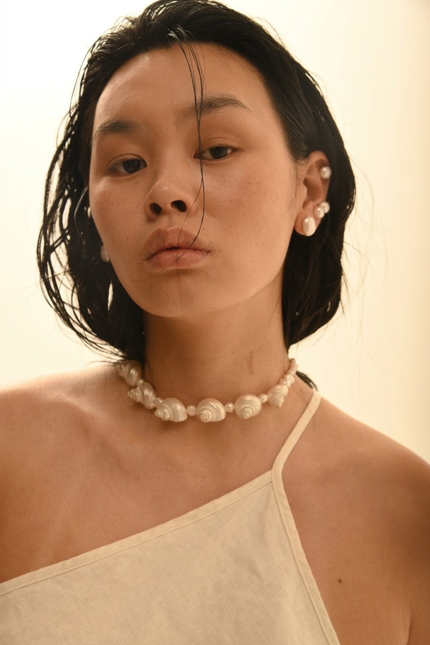 SirenCore pearl and seven-shell choker worn around the neck
