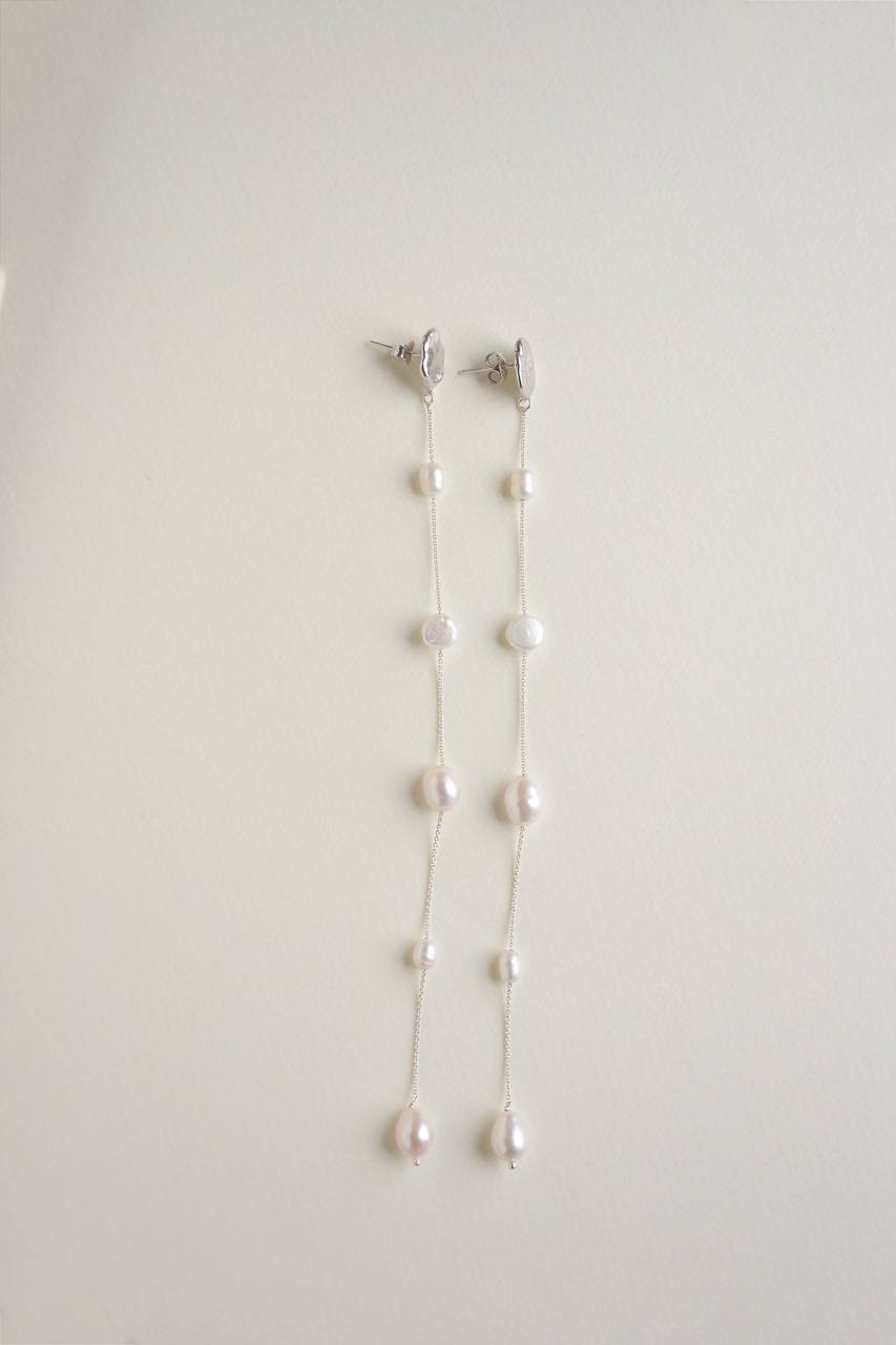 Side view of the Fonte statement earrings showing their elongated design