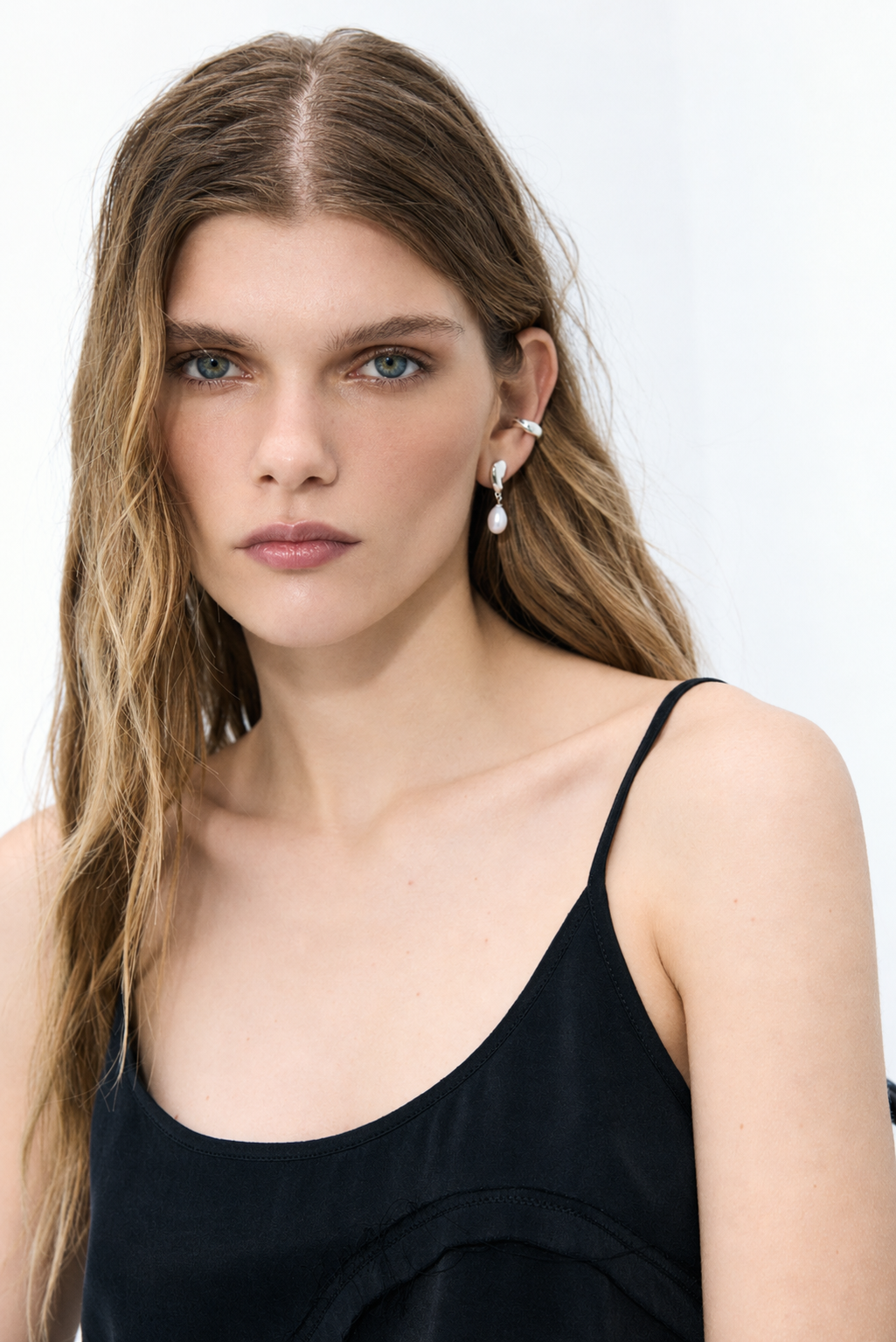 DEW pearl drop earrings featuring fluid silver forms and luminous natural pearls