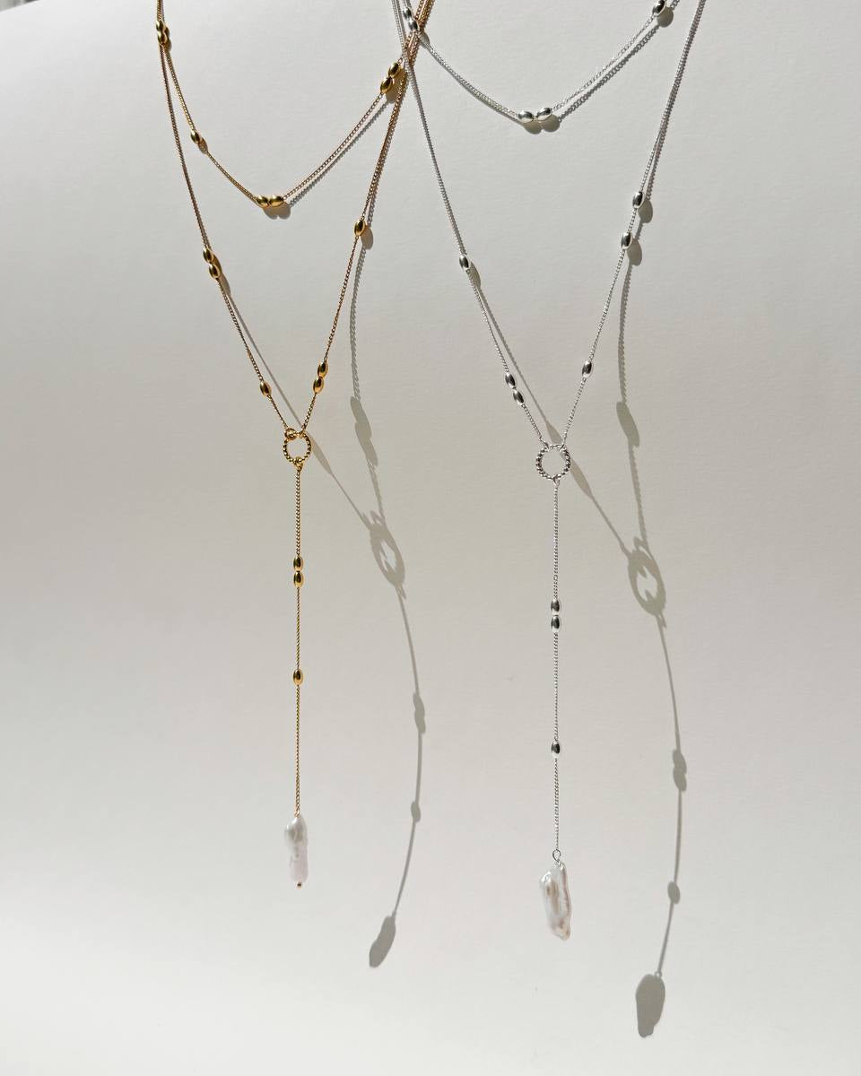 Olive sterling silver necklace with elongated beads and a natural baroque pearl pendant