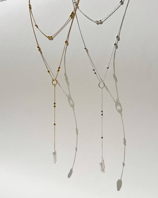 Olive sterling silver necklace with elongated beads and a natural baroque pearl pendant