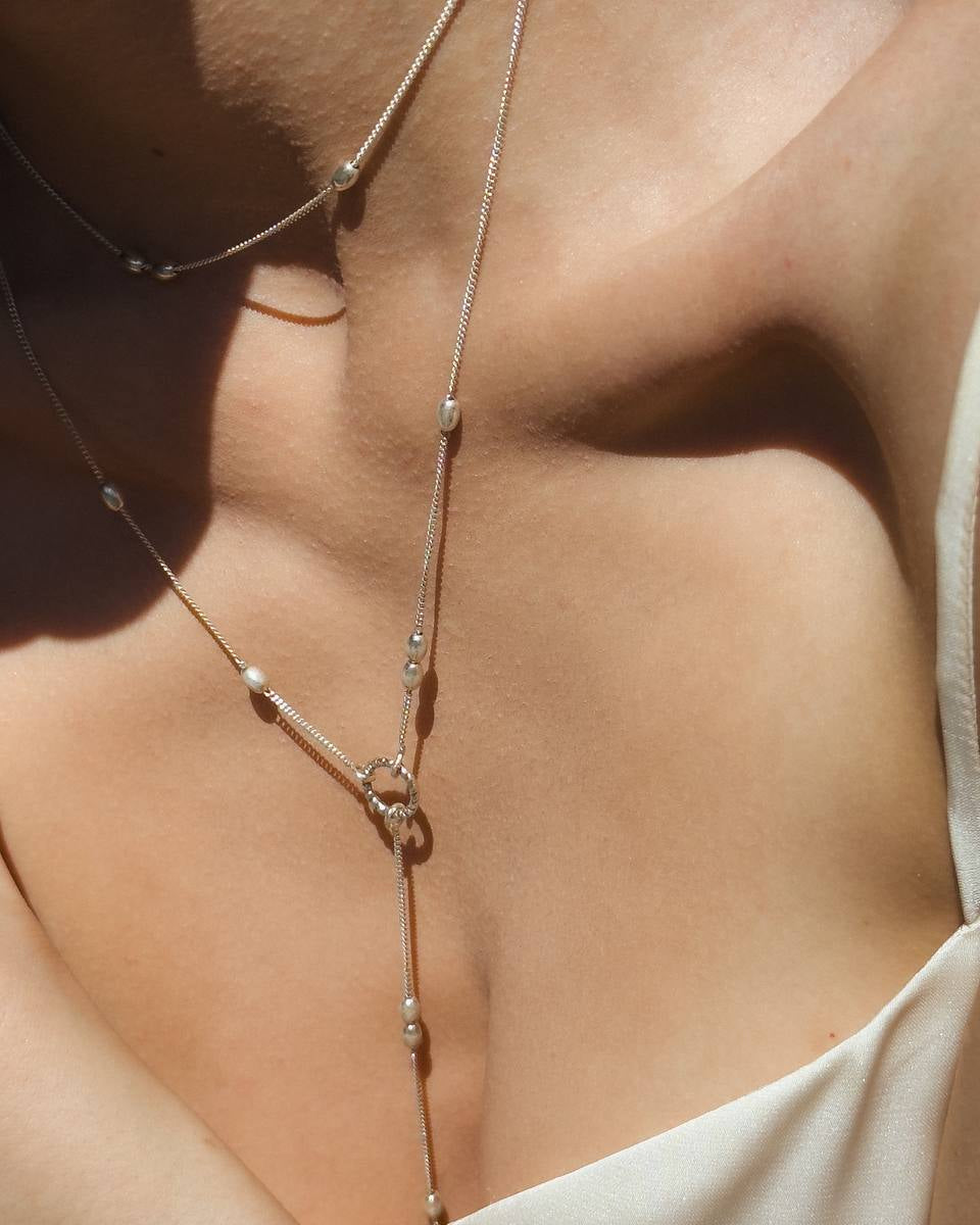 Close-up of the Olive necklace showing its silver olive-shaped beads 