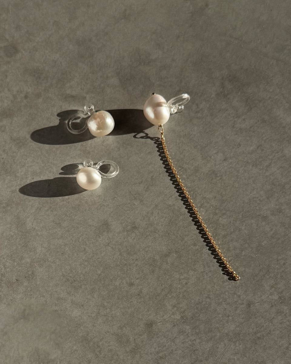 Three-piece pearl ear cuff set with round natural pearls, a baroque pearl, and a gold-plated chain