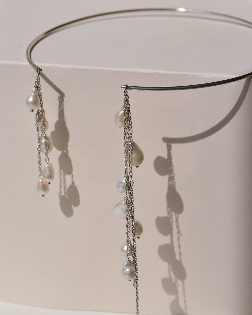 Close-up of the BORA BORA silver necklace showing cascading chains and natural drop-shaped pearls