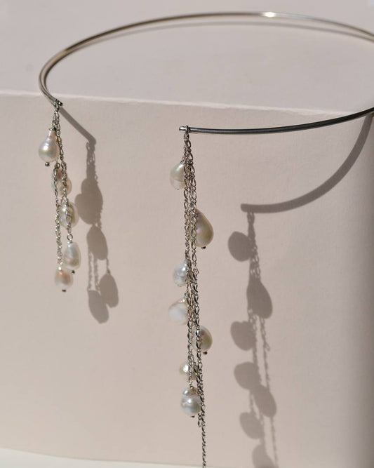 Close-up of the BORA BORA silver necklace showing cascading chains and natural drop-shaped pearls