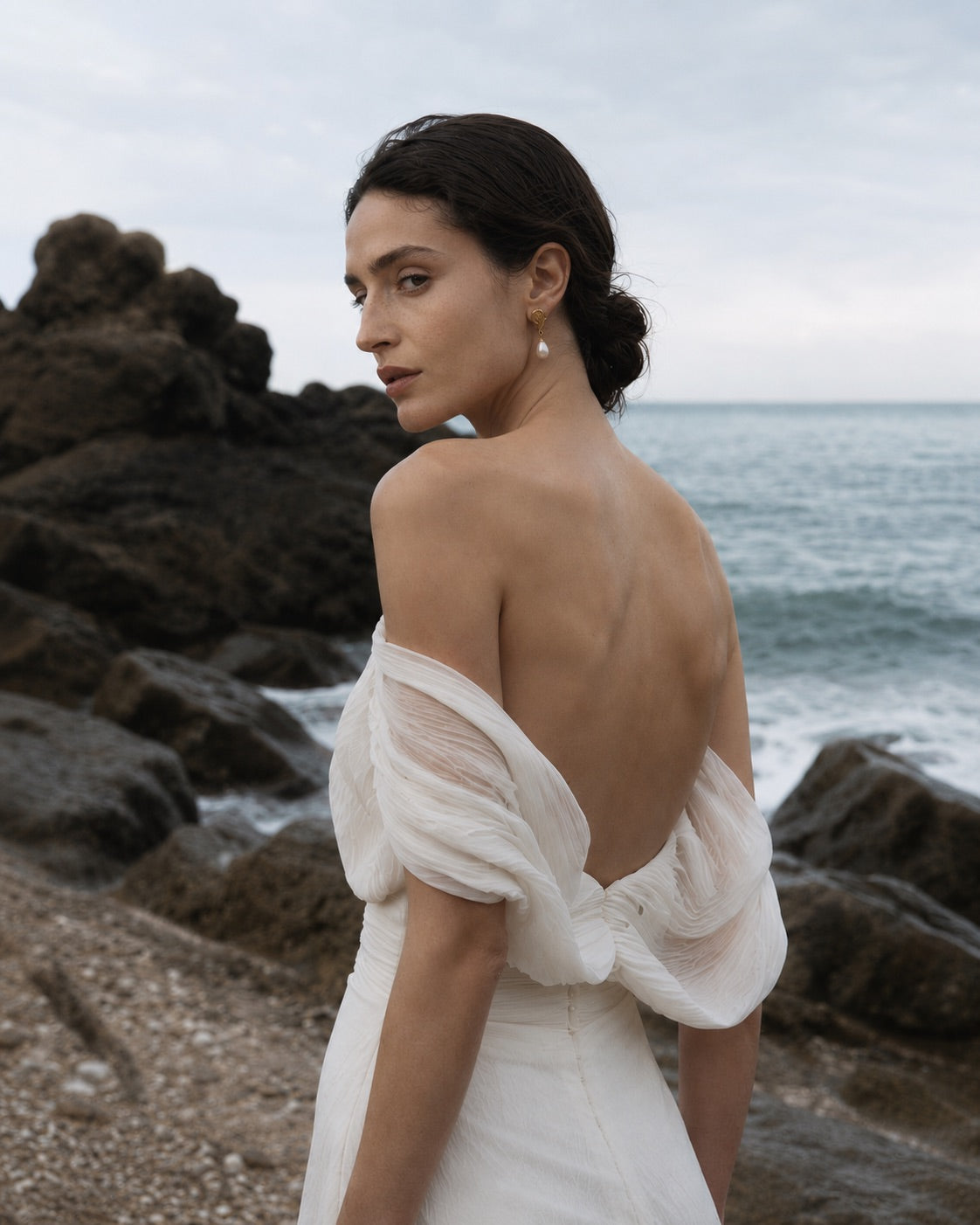 Bride wearing DEW sculptural pearl drop earrings in 24K gold-plated sterling silver
