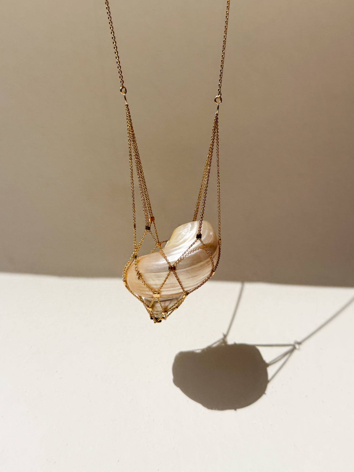 SirenCore long sterling silver necklace with a sculptural shell pendant in 24k gold plating