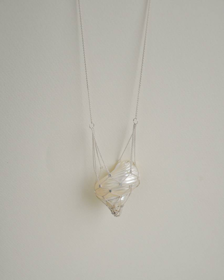 SirenCore shell pendant necklace with an ocean shell encased in a hand-woven 925 sterling silver chain net
