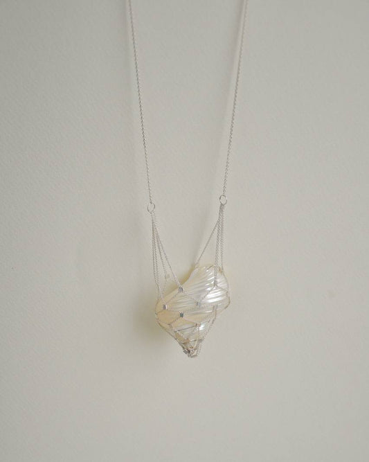 SirenCore shell pendant necklace with an ocean shell encased in a hand-woven 925 sterling silver chain net